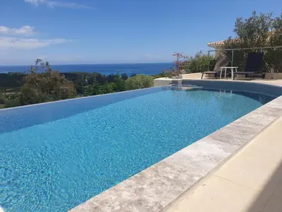 a swimming pool with a view of the ocean at Maison au calme avec vue magnifique in Sari Solenzara