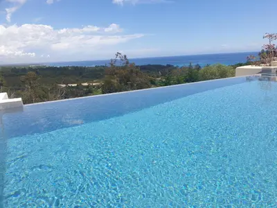 a swimming pool with a view of the ocean at Maison au calme avec vue magnifique in Sari Solenzara