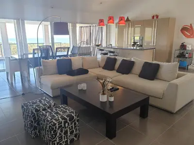 a living room with a couch and a table at Maison au calme avec vue magnifique in Sari Solenzara