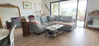 a living room with a couch and a table at T3 vue mer proche plage in Ajaccio