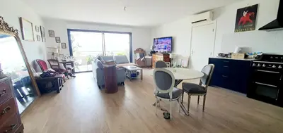 a living room with a table and chairs at T3 vue mer proche plage in Ajaccio