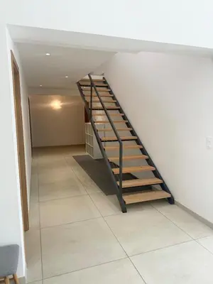 a staircase in a room with a white wall at Villa - Porto-Vecchio - Piscine privée in Porto-Vecchio