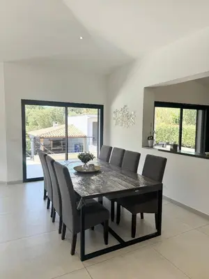 a dining room with a table and chairs at Villa - Porto-Vecchio - Piscine privée in Porto-Vecchio