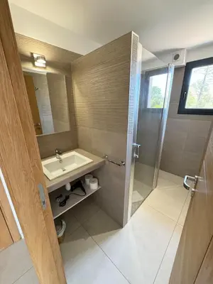 a bathroom with a sink and a shower at Villa - Porto-Vecchio - Piscine privée in Porto-Vecchio