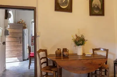 a dining room with a wooden table and chairs at Casa Di Babbo in Olmi-Cappella