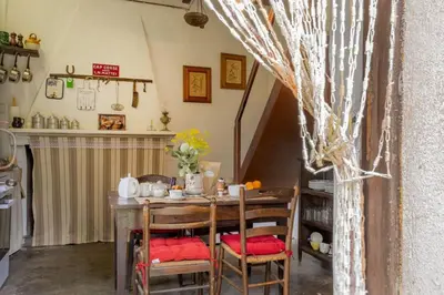 a kitchen with a table and chairs in a room at Casa Di Babbo in Olmi-Cappella