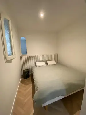 a bed in a small room with a window at Charmant appartement T2 hypercentre à Ajaccio in Ajaccio