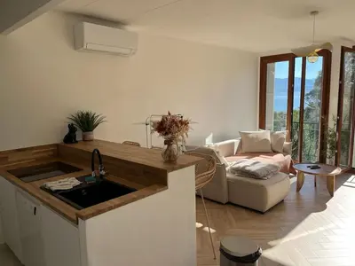 a kitchen with a sink and a living room at Charmant appartement T2 hypercentre à Ajaccio in Ajaccio
