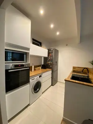 a kitchen with a washing machine and a sink at Charmant appartement T2 hypercentre à Ajaccio in Ajaccio