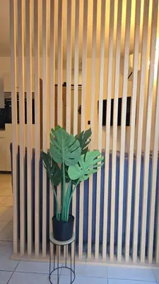 a potted plant sitting on a stool next to a wall at New Superbe F2 refait à neuf tout confort avec piscine et mer à pied in Serra-di-Ferro