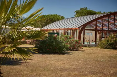 a building with a bunch of flowers in front of it at Camping Domaine d'Anghione in Castellare-di-Casinca