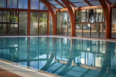 a swimming pool in a house with windows at Camping Domaine d'Anghione in Castellare-di-Casinca