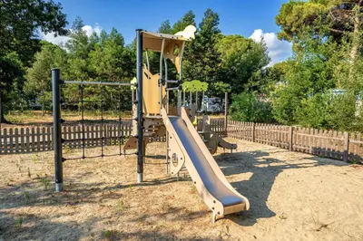 a playground with a slide in a park at Camping Domaine d'Anghione in Castellare-di-Casinca