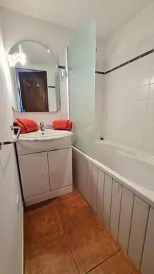 a bathroom with a sink and a mirror and a tub at Villa 4 à 5 pers T2 climatisée & wifi résidence piscine et mer à pied in Serra-di-Ferro