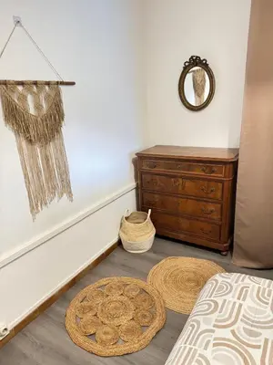 a bedroom with a bed and a dresser and a mirror at Fiori di sperenza in Coggia