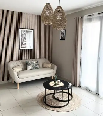 a living room with a couch and a table at Charmant T2 lumineux avec terrasse in Propriano