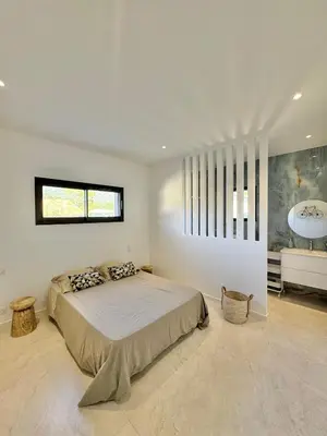 a bedroom with a large bed and a bathroom at Villa Porto-Vecchio avec piscine in Lecci