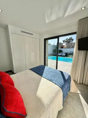 a bedroom with a bed and a view of a pool at Villa Porto- Vecchio avec piscine 8 pers in Lecci