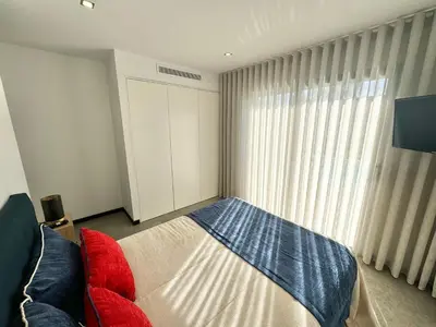 a bedroom with a bed and a couch and a window at Villa Porto- Vecchio avec piscine 8 pers in Lecci