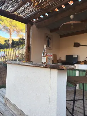 a bottle of wine sitting on top of a bar at Tradition Corse & Modernité I Caseddi di Barabè in Granace
