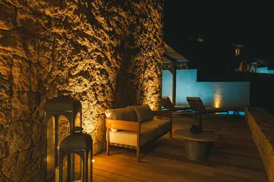 a living room with a couch on a deck at night at Casi di Mare in Cargèse