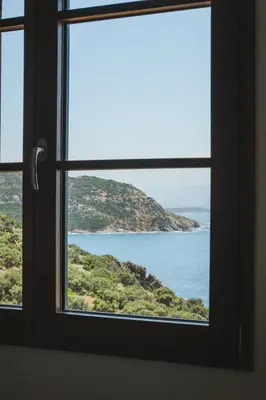 a window with a view of the ocean at Casi di Mare in Cargèse