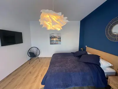 a bedroom with a bed with a blue wall at Casa Culomba in Morta