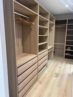 a walk in closet with wooden shelves and wooden floors at Casa Culomba in Morta