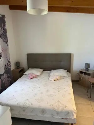 a bedroom with a bed with two pillows on it at Bonifacio tranquillité paradis in SantʼAmanza