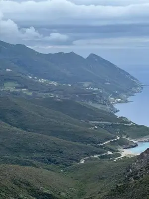 a view of a mountain range with a body of water at Bonifacio tranquillité paradis in SantʼAmanza