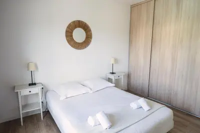 a bedroom with two beds and a mirror on the wall at Villa de standing Vista - Domaine Romella - Piscine - Vue Lac de Padula in Oletta