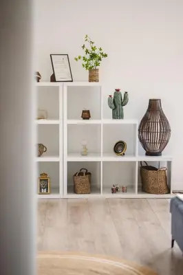 a white book shelf with plants and vases on it at Villa de standing Vista - Domaine Romella - Piscine - Vue Lac de Padula in Oletta