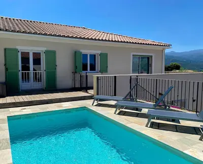 a swimming pool in front of a house at Villa de standing Vista - Domaine Romella - Piscine - Vue Lac de Padula in Oletta