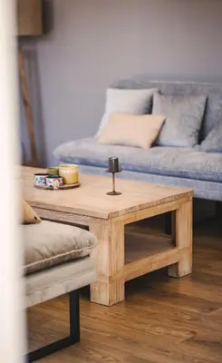 a wooden coffee table in a living room with a couch at Villa de standing Fiurenza - Domaine Romella - Piscine - Proche Saint-Florent in Oletta