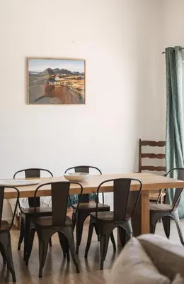 a dining room with wooden tables and chairs at Villa de standing Fiurenza - Domaine Romella - Piscine - Proche Saint-Florent in Oletta