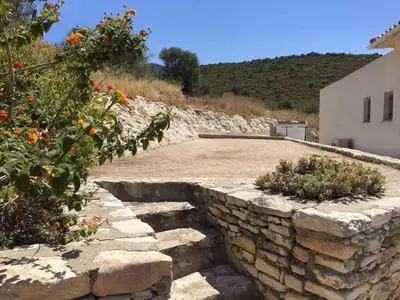 a stone retaining wall with stairs in a yard at Villa de standing Fiurenza - Domaine Romella - Piscine - Proche Saint-Florent in Oletta