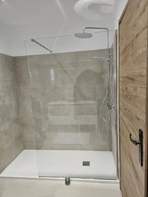 a shower with a glass door in a bathroom at Villa de standing Fiurenza - Domaine Romella - Piscine - Proche Saint-Florent in Oletta