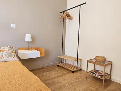 a bedroom with a bed and a lamp and a table at Villa de standing Fiurenza - Domaine Romella - Piscine - Proche Saint-Florent in Oletta
