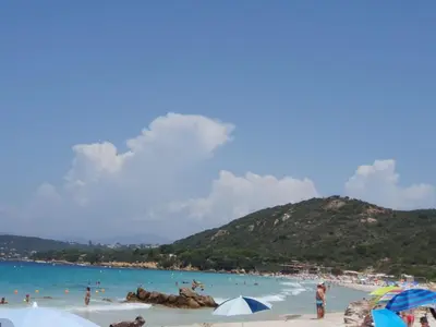 a group of people on a beach with umbrellas at Bella Vista 4, T2 vue mer, piscine, climatisé Porticcio in Porticcio