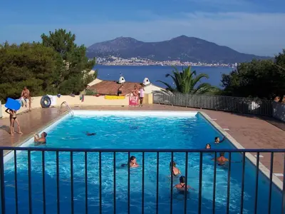 a group of people in a swimming pool at Bella Vista 4, T2 vue mer, piscine, climatisé Porticcio in Porticcio