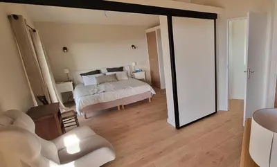 a bedroom with a bed and a mirror at Maison de standing avec piscine vue mer Corse du sud Pozzaccio, Portigliolo 2 à 6 personnes 3 chambres in Coti-Chiavari