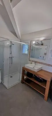 a bathroom with a shower and a sink and a mirror at Maison de standing avec piscine vue mer Corse du sud Pozzaccio, Portigliolo 2 à 6 personnes 3 chambres in Coti-Chiavari