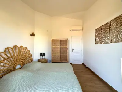 a bedroom with a large bed in a room at Villa vue mer, spacieuse, piscine privée in Sari Solenzara