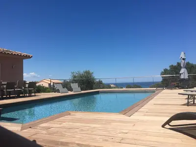 a swimming pool with a view of the ocean at Villa vue mer, spacieuse, piscine privée in Sari Solenzara