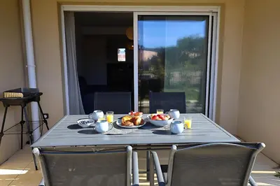 a table with a bowl of food on it at Villa Tranquille - Maison 4 étoiles 2 Chambres Bonifacio in Bonifacio