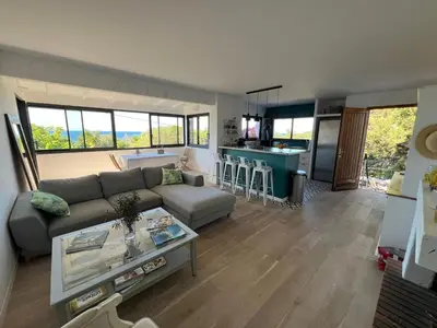 a living room with a couch and a table at Maison à 50 m de la plage, 10 personnes, 5 chambres en corse du sud, in Coti-Chiavari
