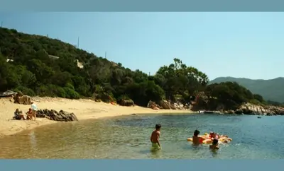 a group of people in the water at a beach at Maison à 50 m de la plage, 10 personnes, 5 chambres en corse du sud, in Coti-Chiavari