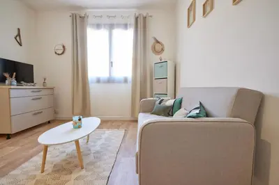 a living room with a couch and a table at Coquet T2 pres des plages in Propriano