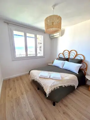 a bedroom with a bed with two towels on it at Appartement Ajaccio vue mer in Ajaccio