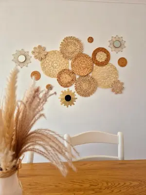 a table with a vase with flowers on a wall at Appartement Ajaccio vue mer in Ajaccio